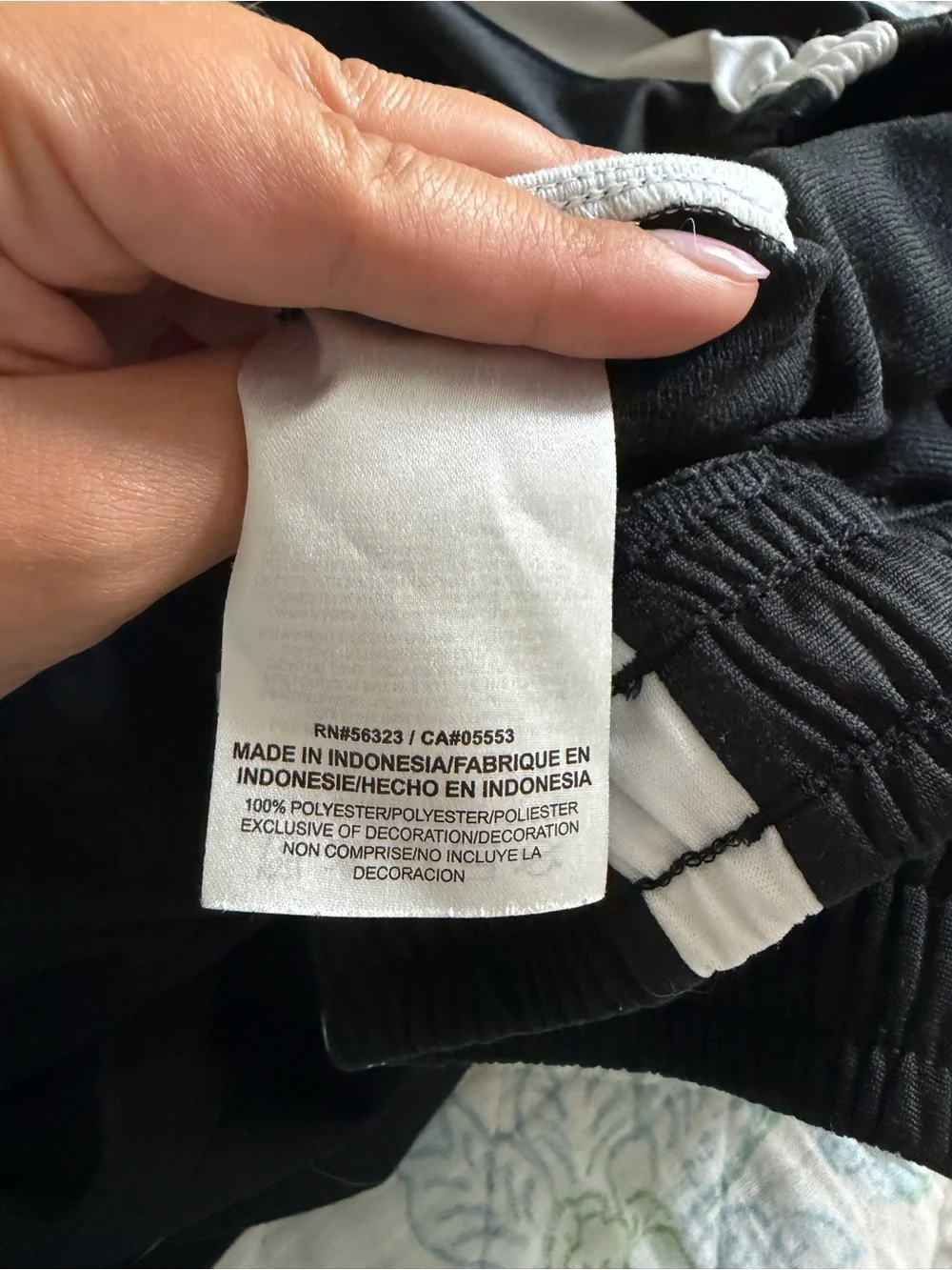 Nike black men’s track pants with white side stripes, size M